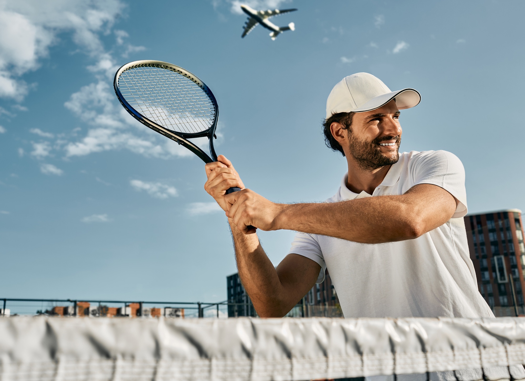 Handsome tennis player while match game with tennis racket in hands before shot over background of Handsome tennis player while match game with tennis racket in hands before shot over background of
